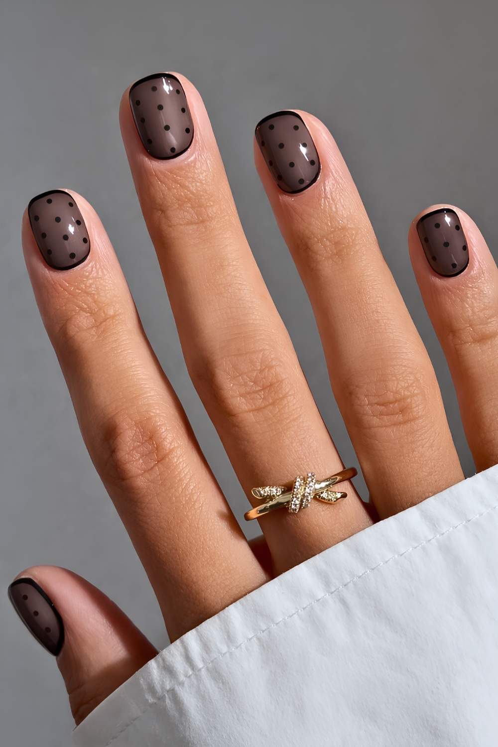 Short black polka dot manicure