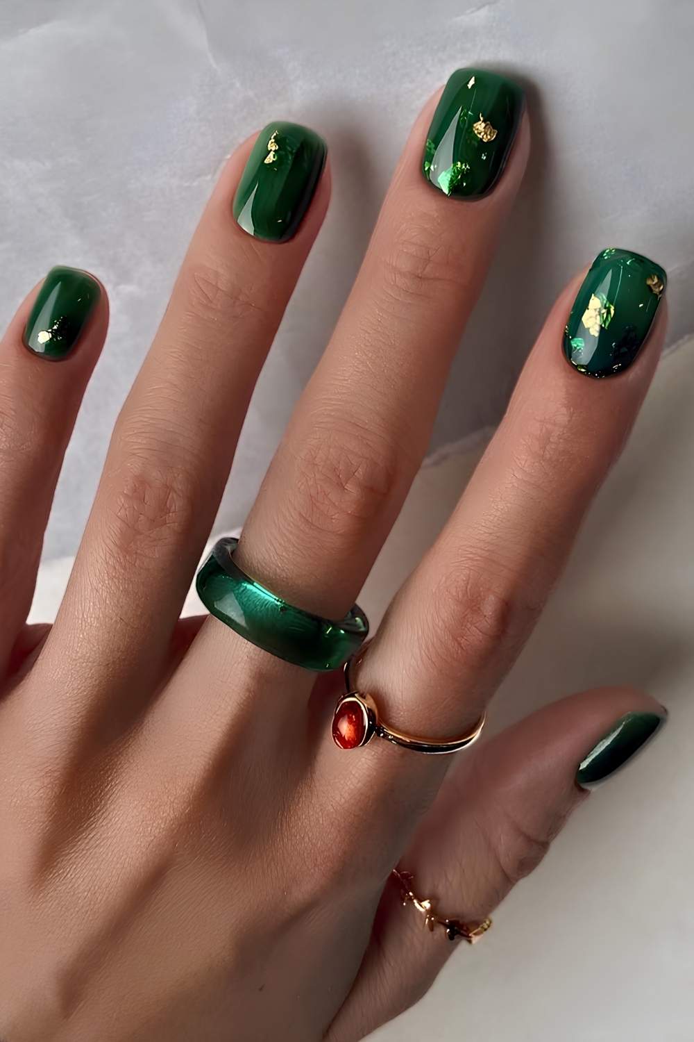 Short dark green nails with accent gold foil