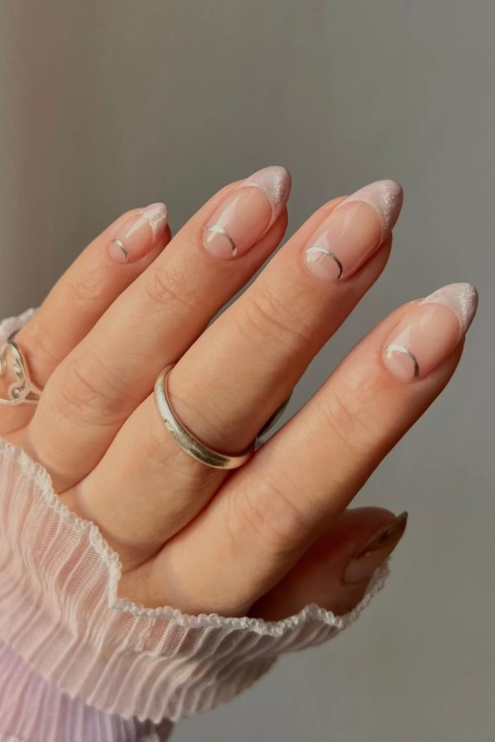 Soft pink French tip nails with half-moon outlines