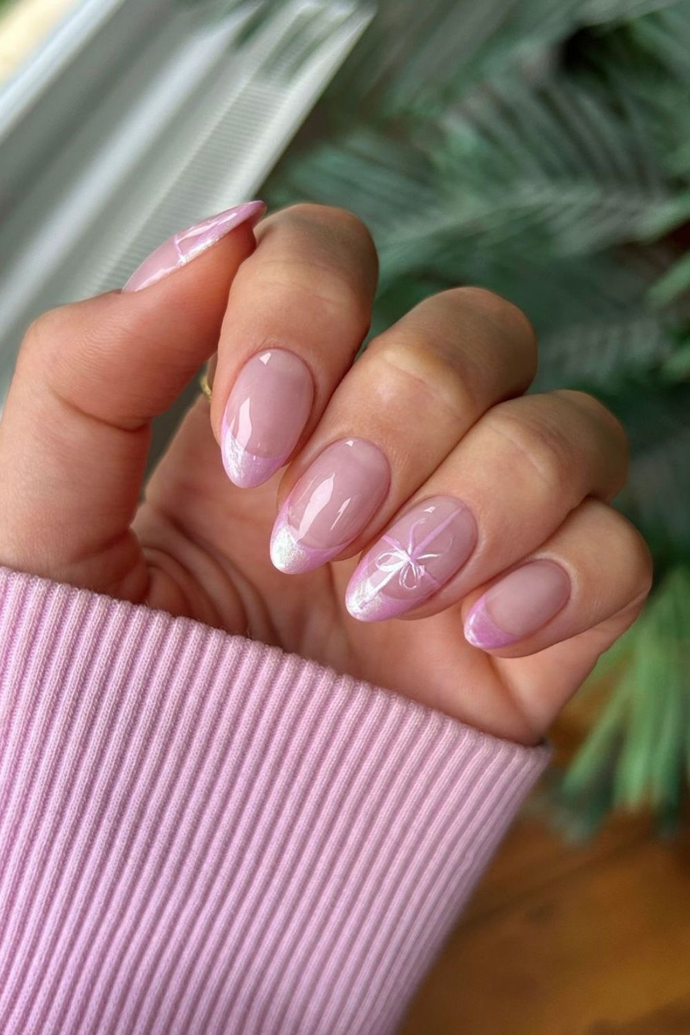 Soft pink French tip nails with ribbon accent