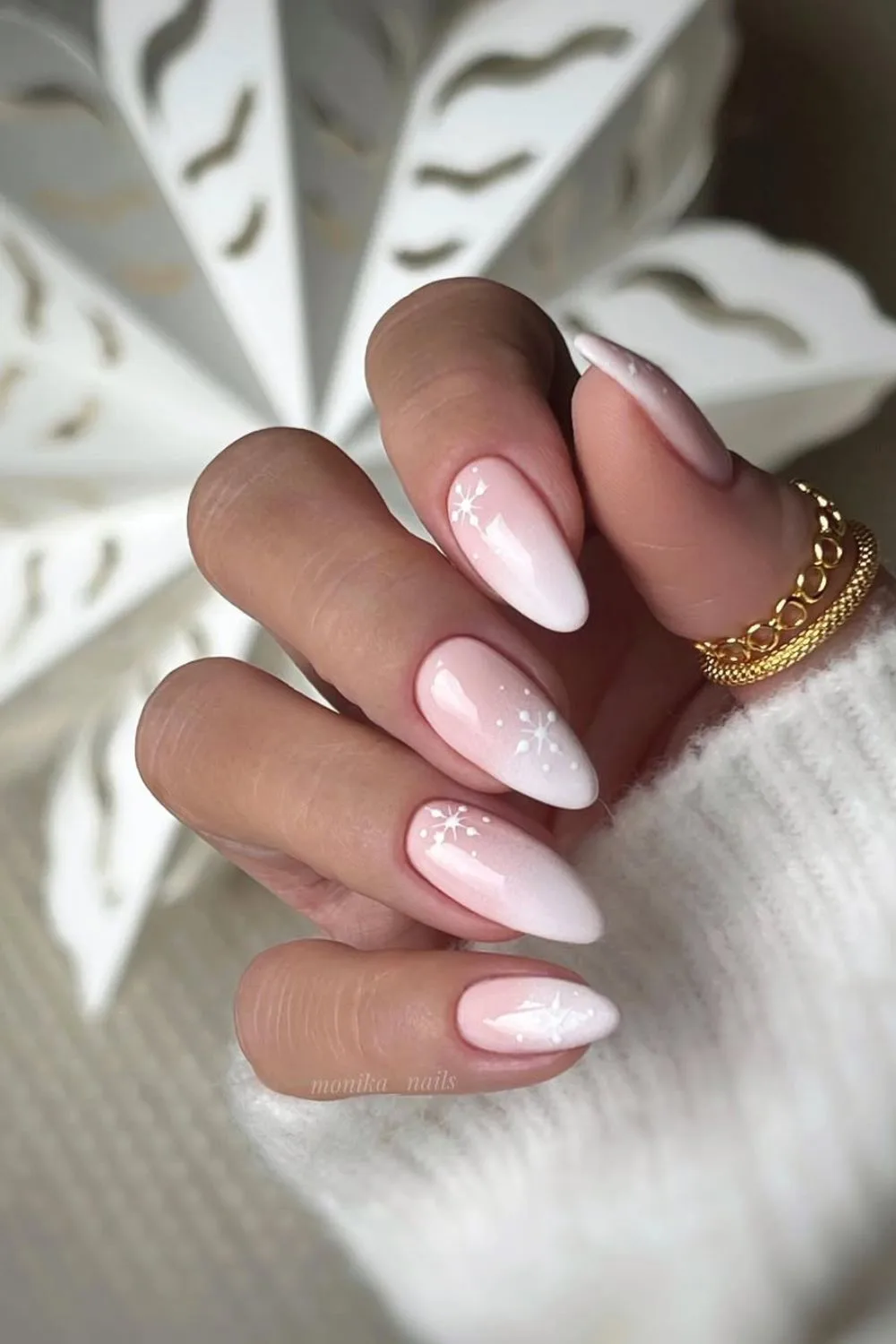 Soft pink and white ombre nails with snowflake accents