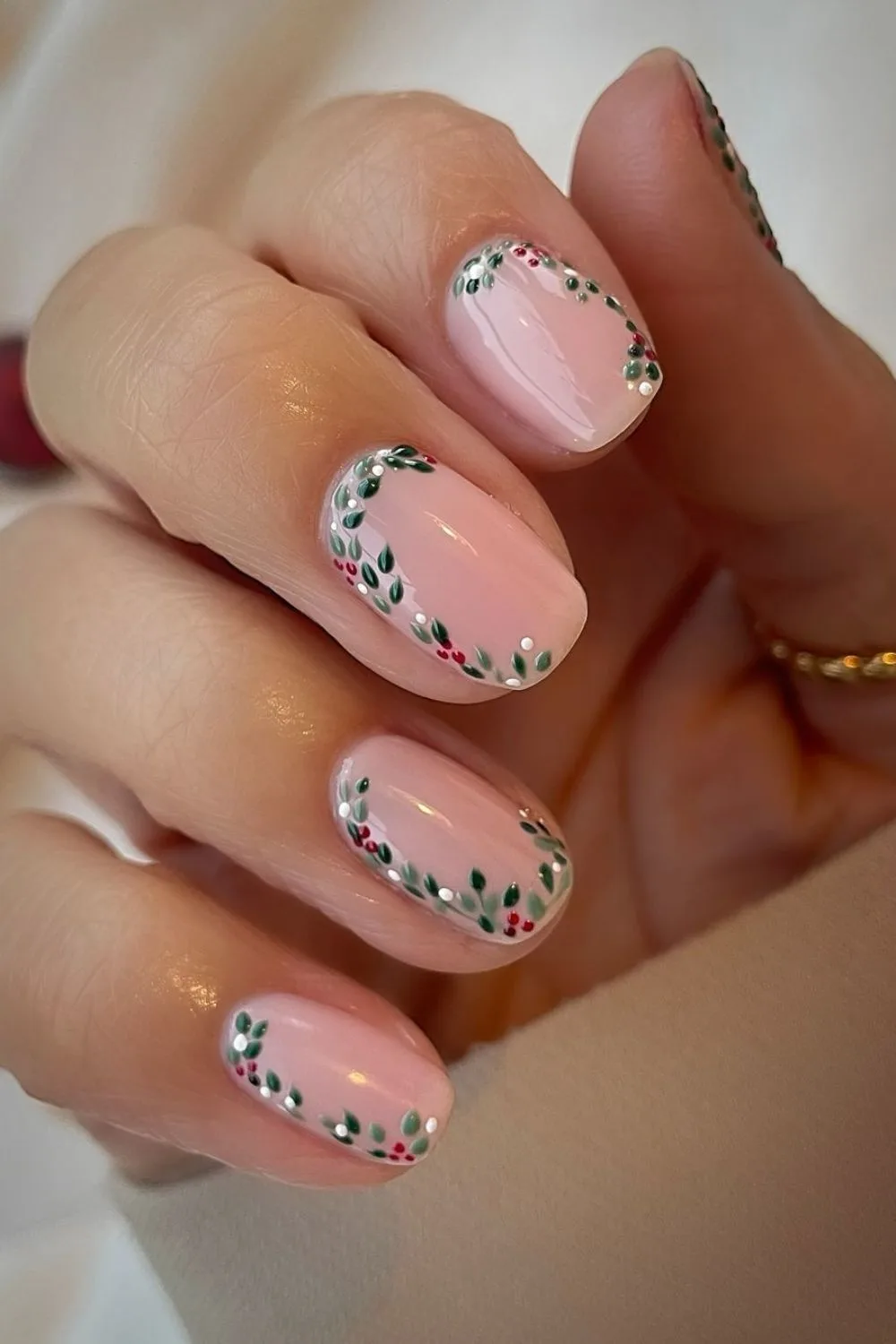 Soft pink nail base with mistletoe accents