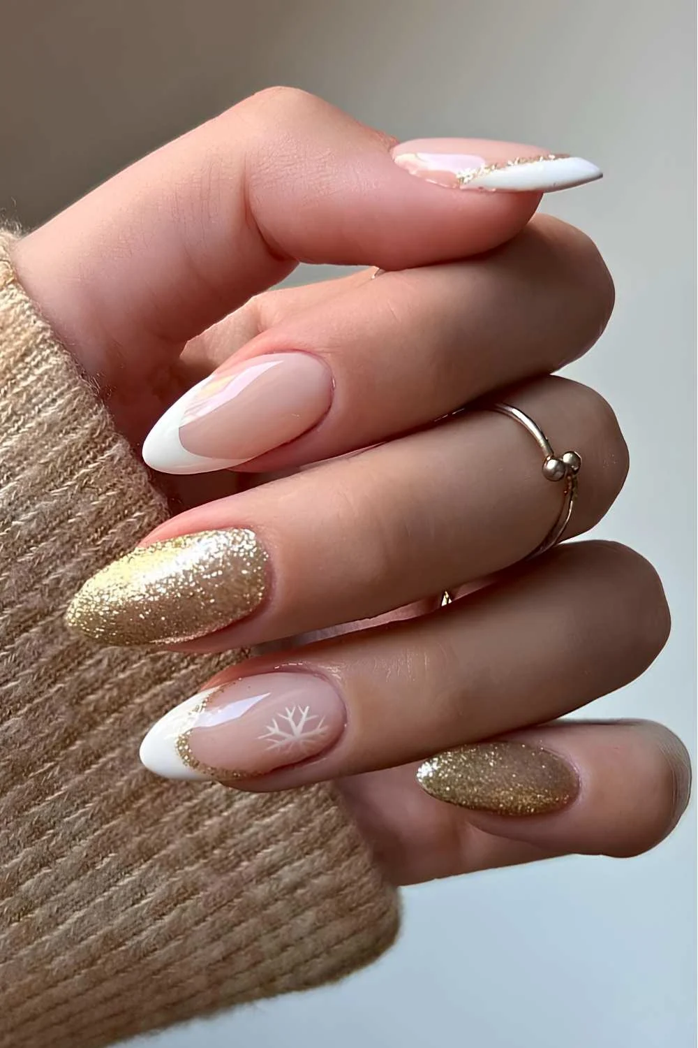 White French mani with gold glitter and snowflakes