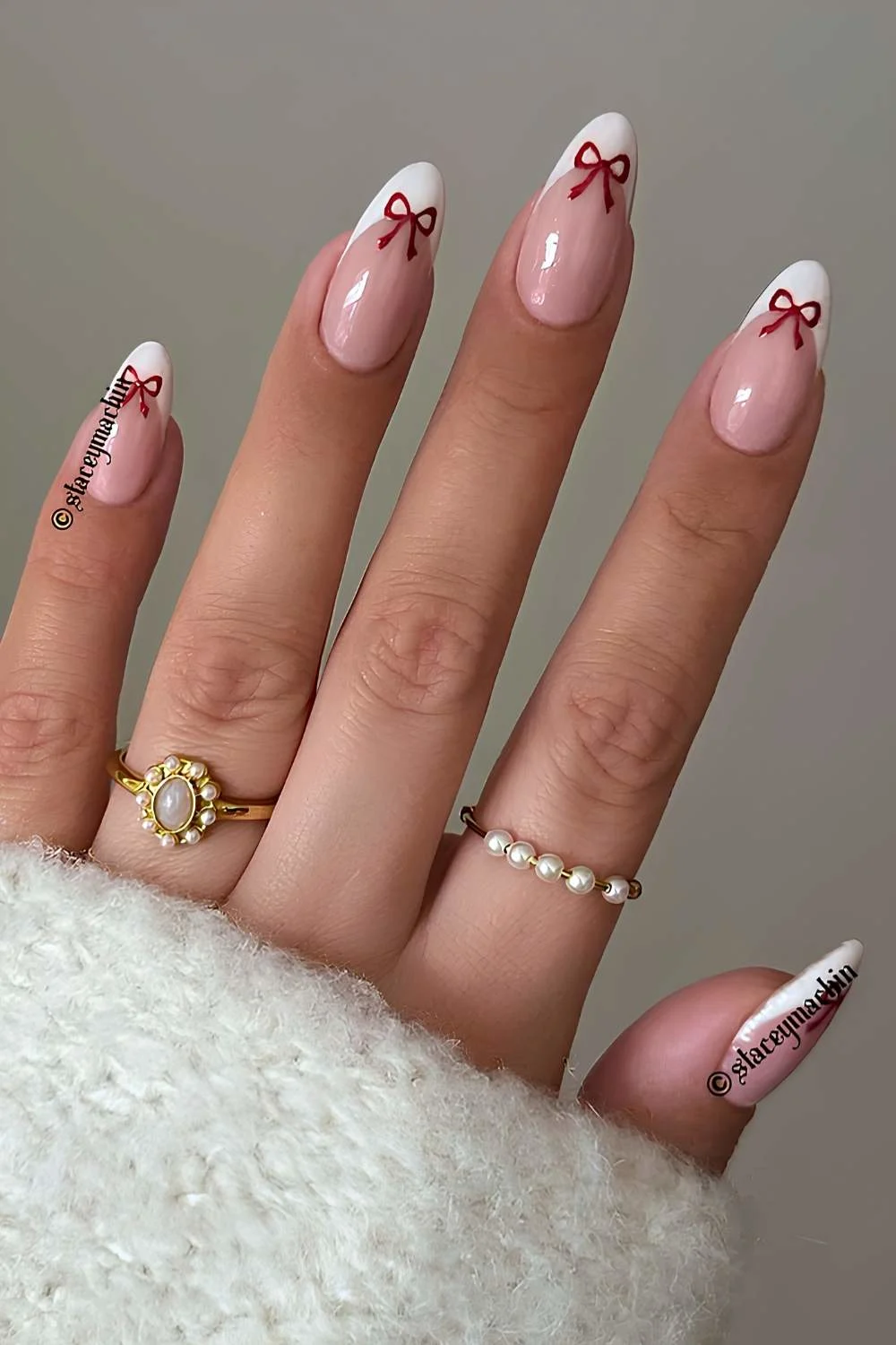 White French manicure with red bow art
