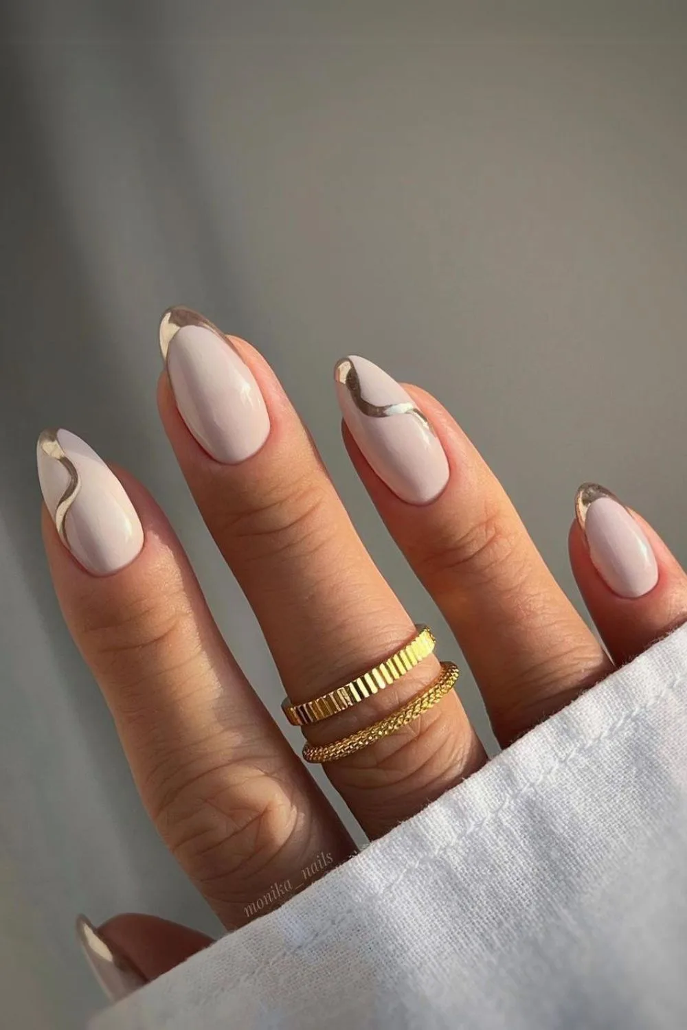 White nails with gold chrome swirls