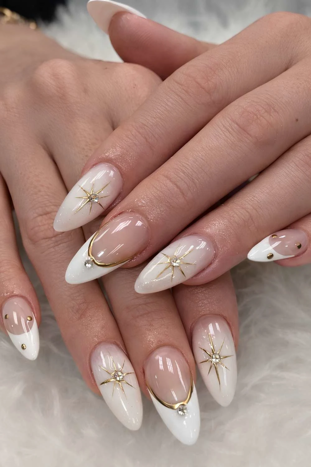 White nails with gold stars and gems