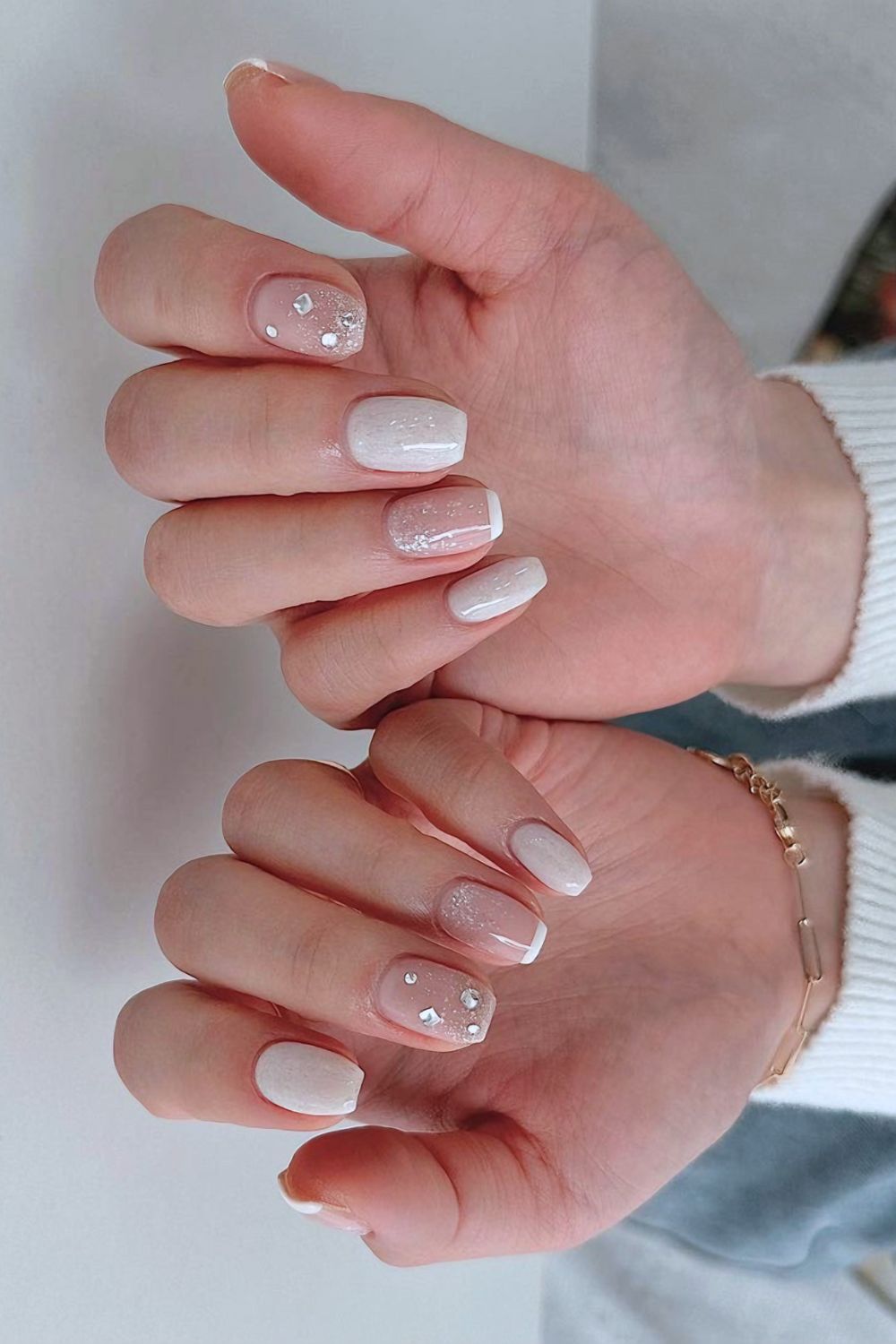 White nails with rhinestone accents