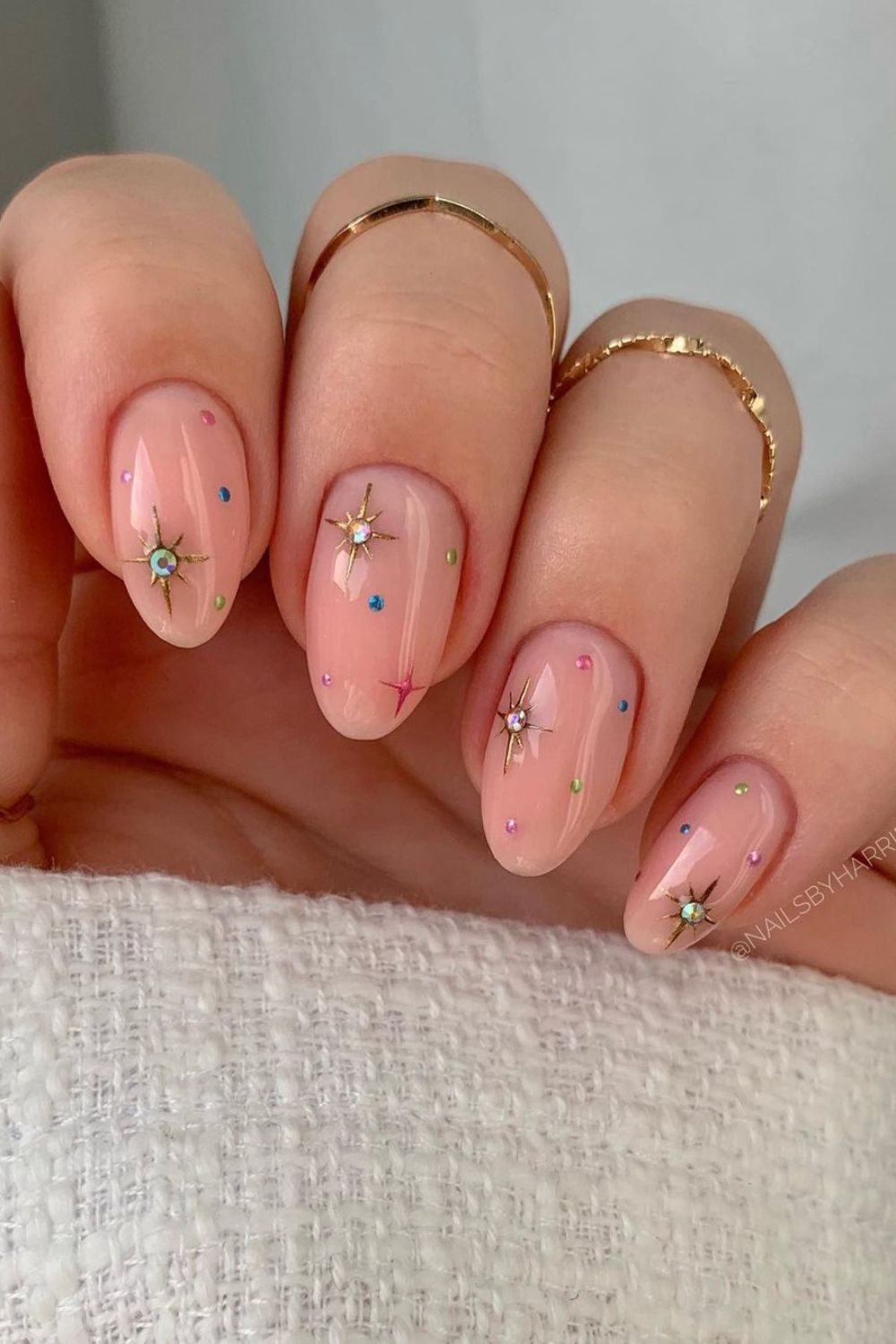 neutral nails with stars and dots in colors