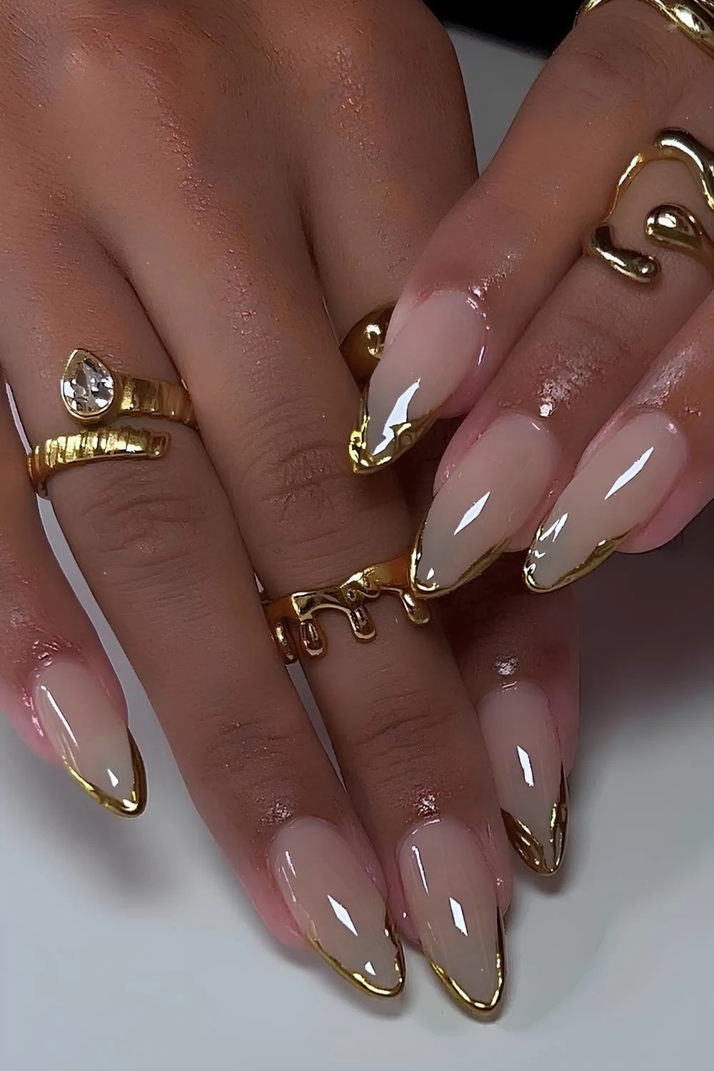Abstract gold chrome French mani on a milky base