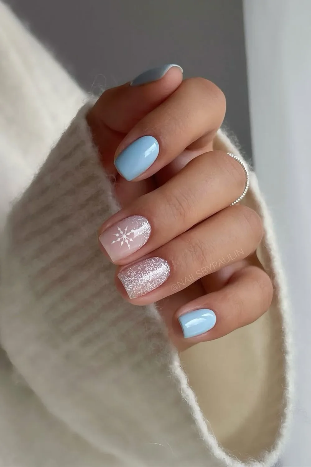 Baby blue and milky white shimmer nails with snowflake on one accent nail