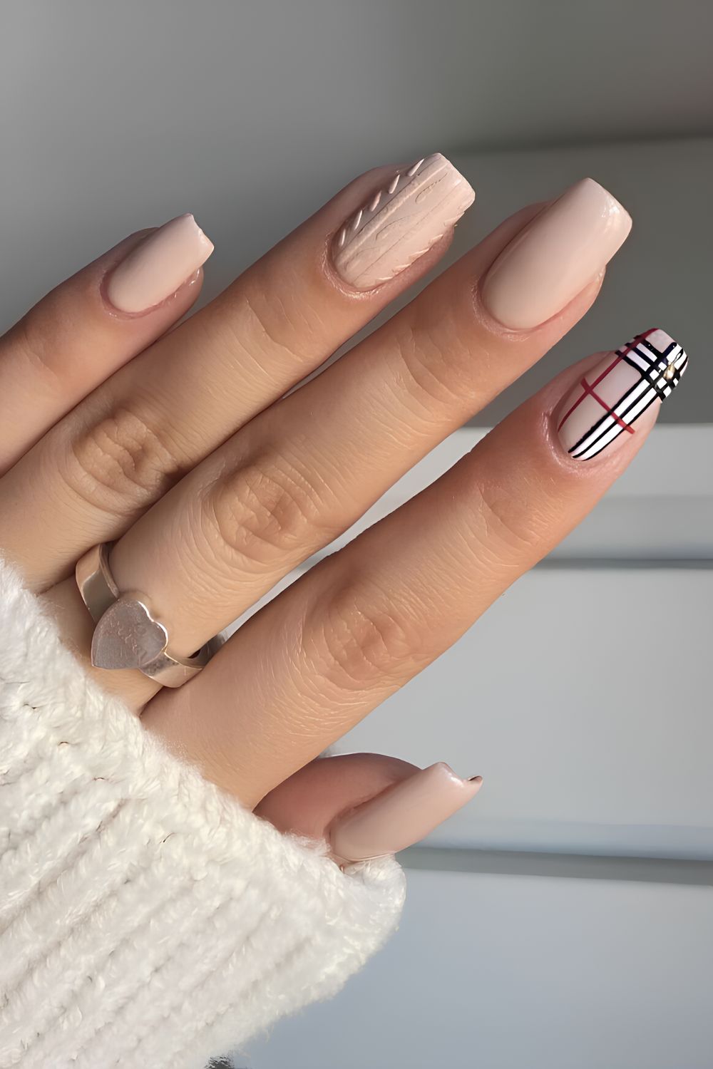 Beige nails with Burberry-inspired plaid and sweater art