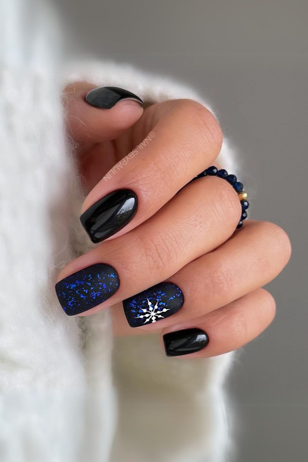 Black and blue nails with snowflakes