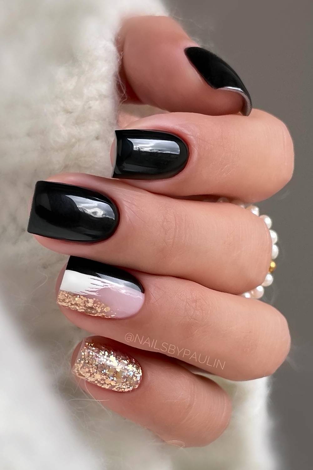 Black and gold mani with glitter and brushstroke accents