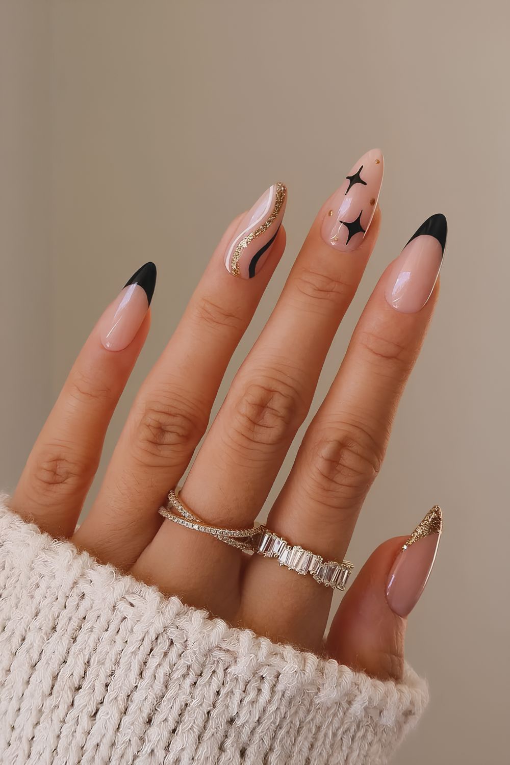 Black and gold nails with swirls and stars