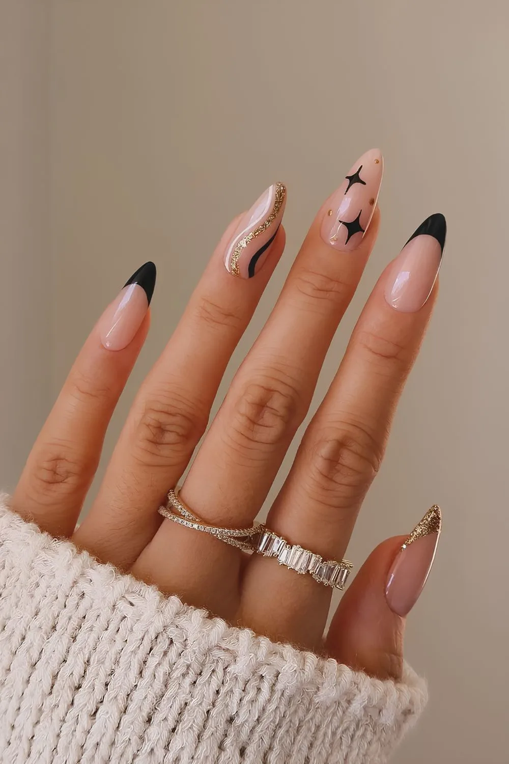 Black and gold nails with swirls and stars