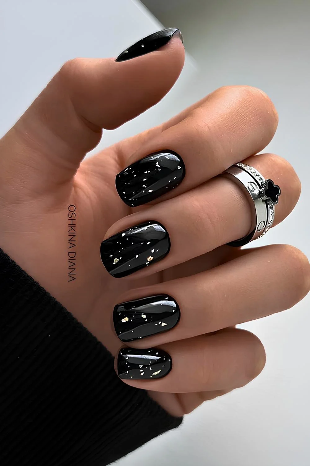 Black nails with accent silver foil flakes