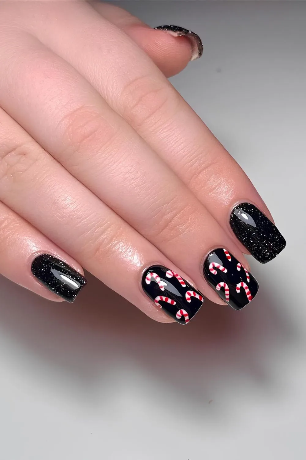 Black nails with candy cane art