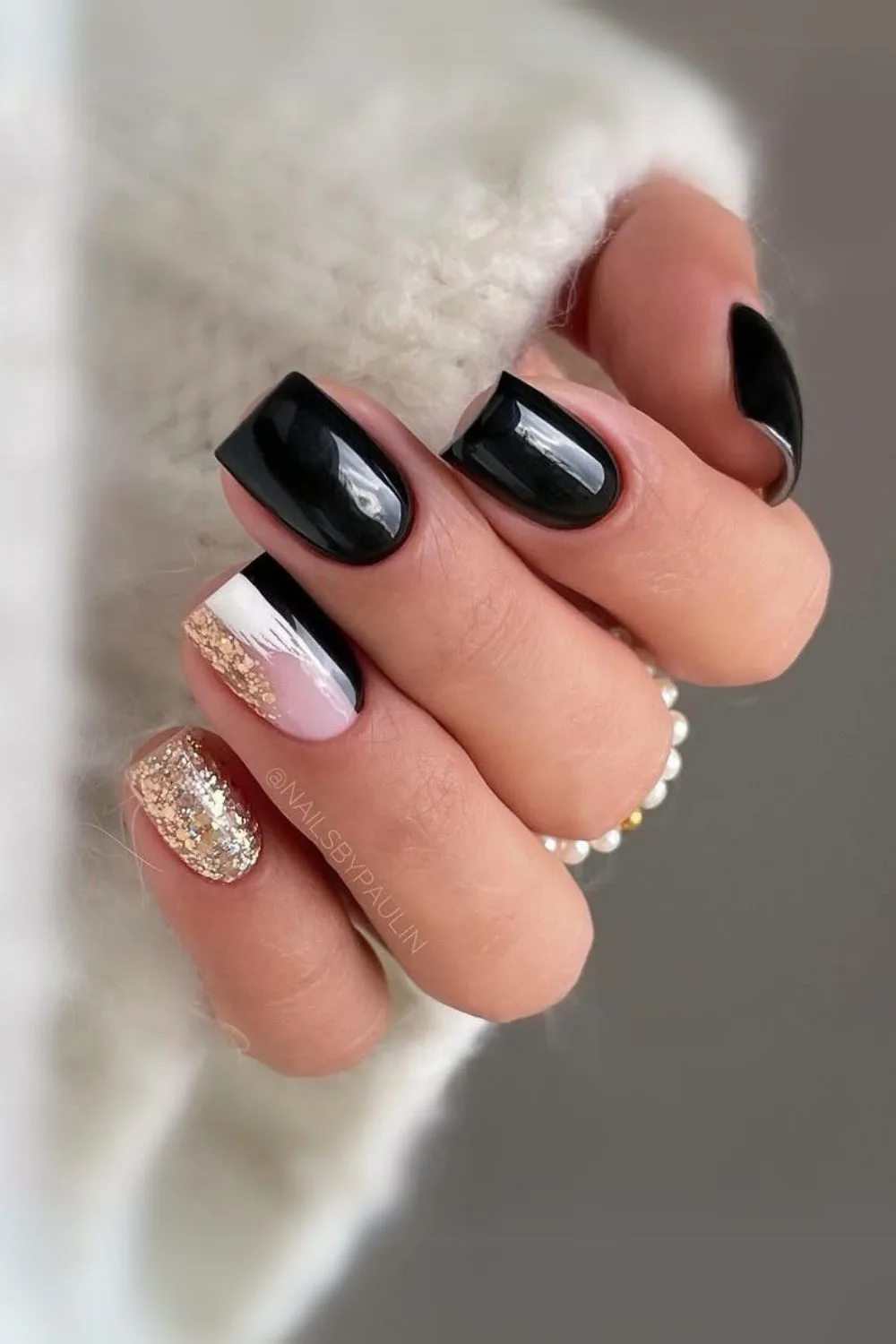 Black nails with gold and white brush stroke accents