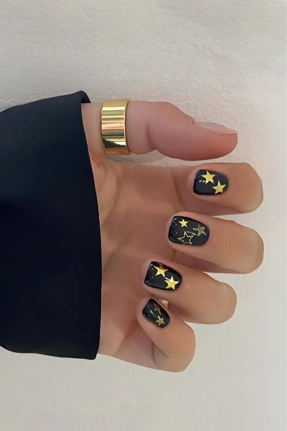 Black nails with gold star art