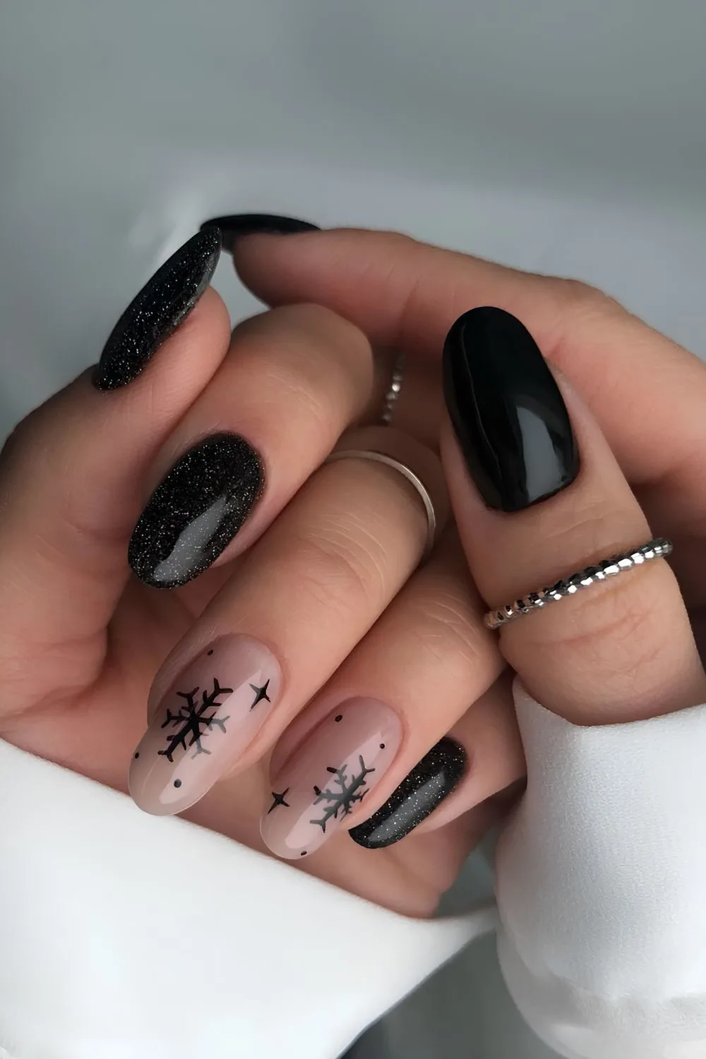 Black nails with shimmer and snowflakes