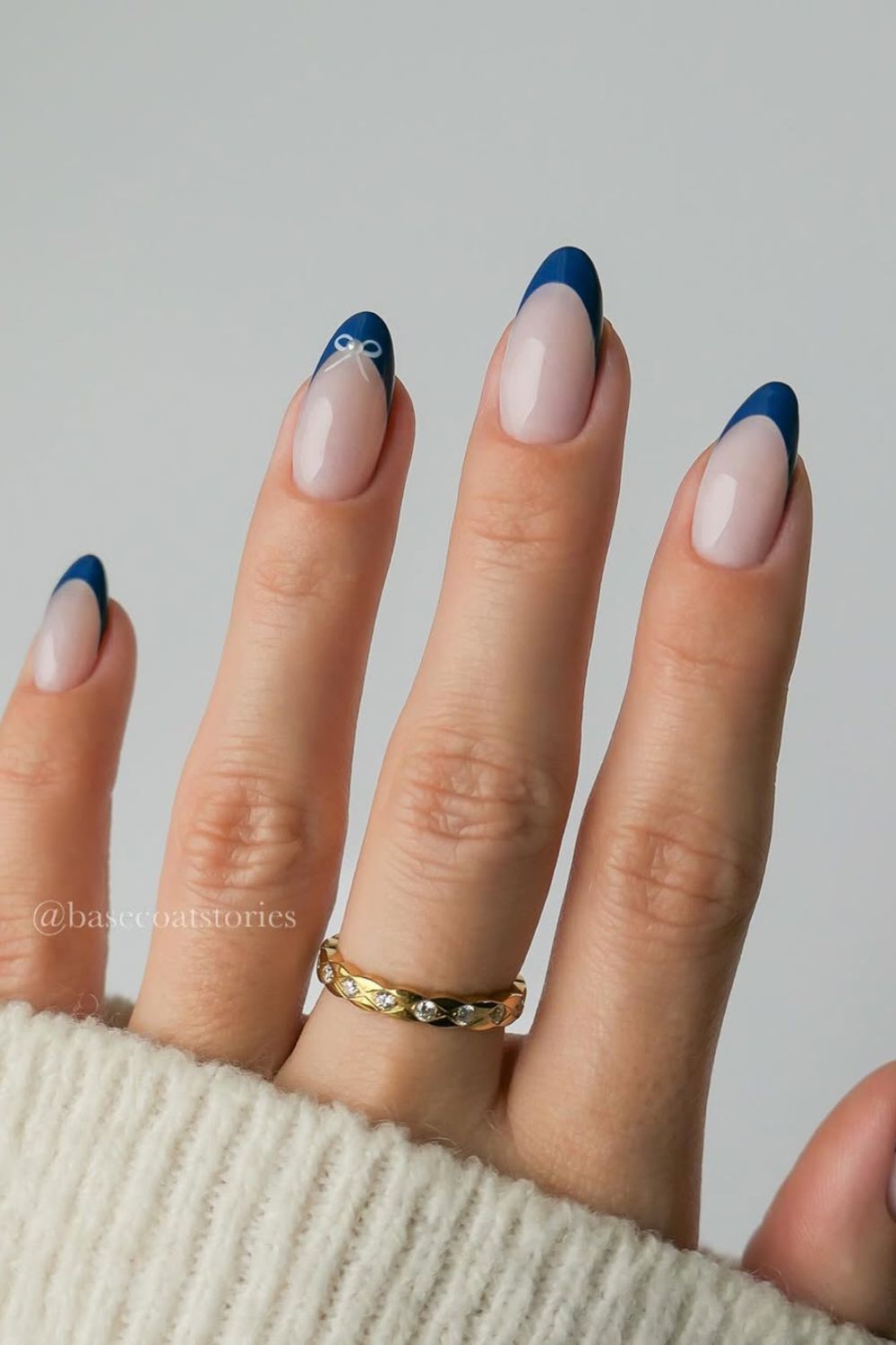 Blue French tip nails with bow accent