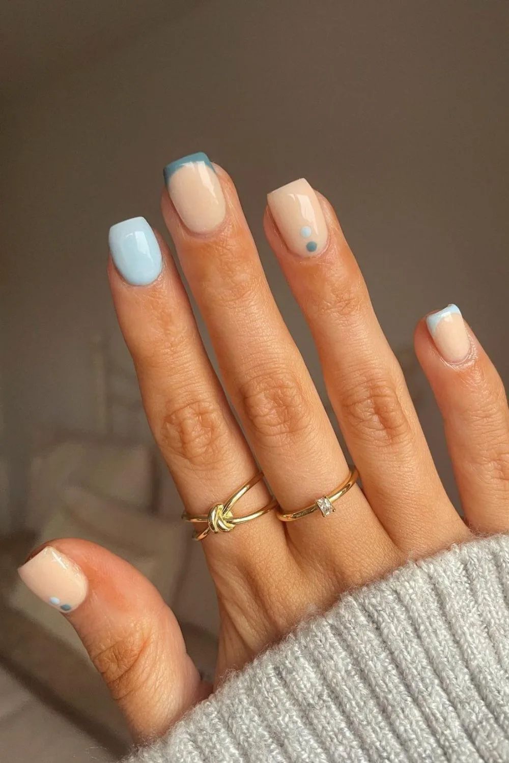 Blue French tip nails with dot accents