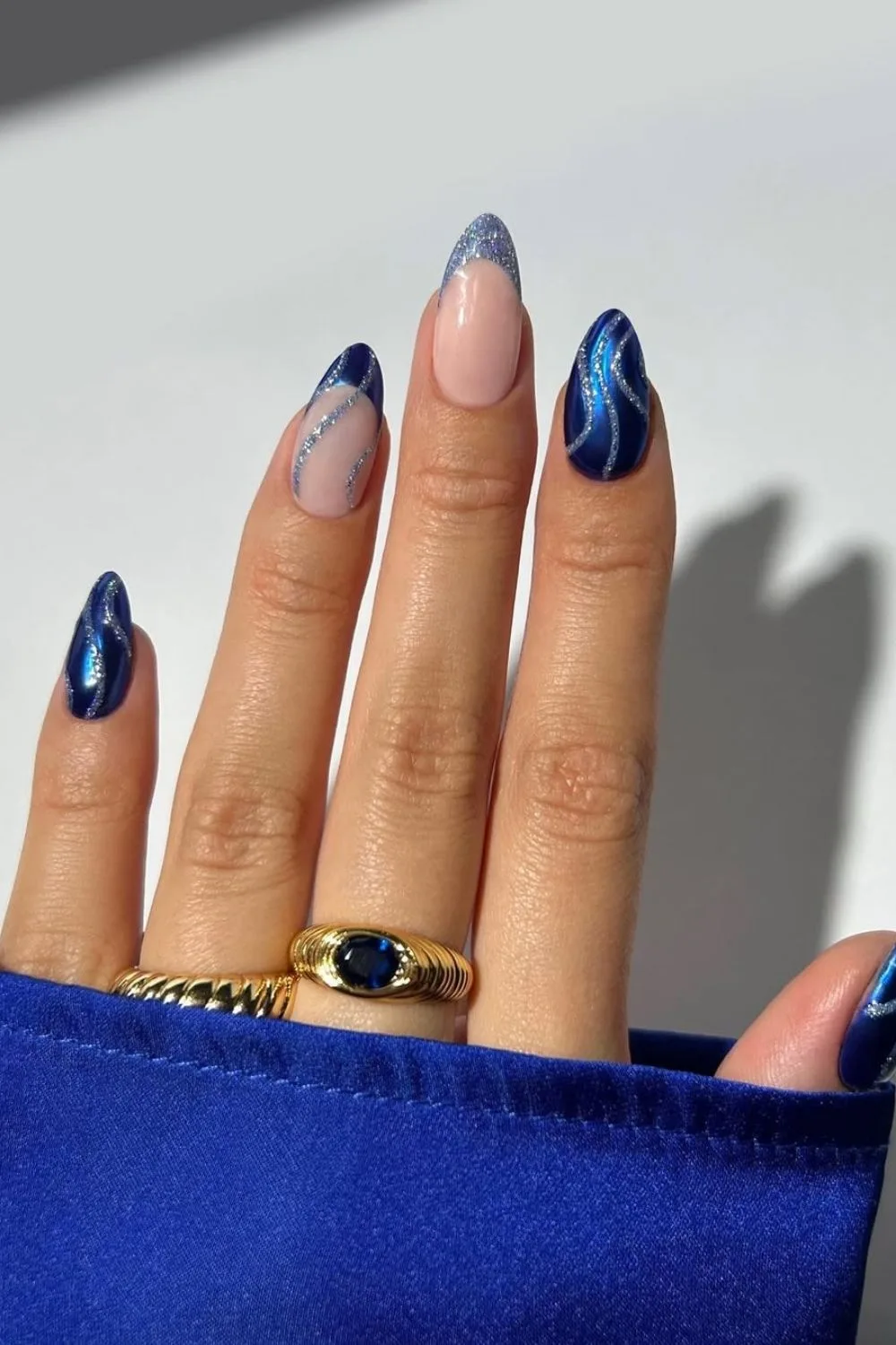 Blue French tip nails with glitter swirls