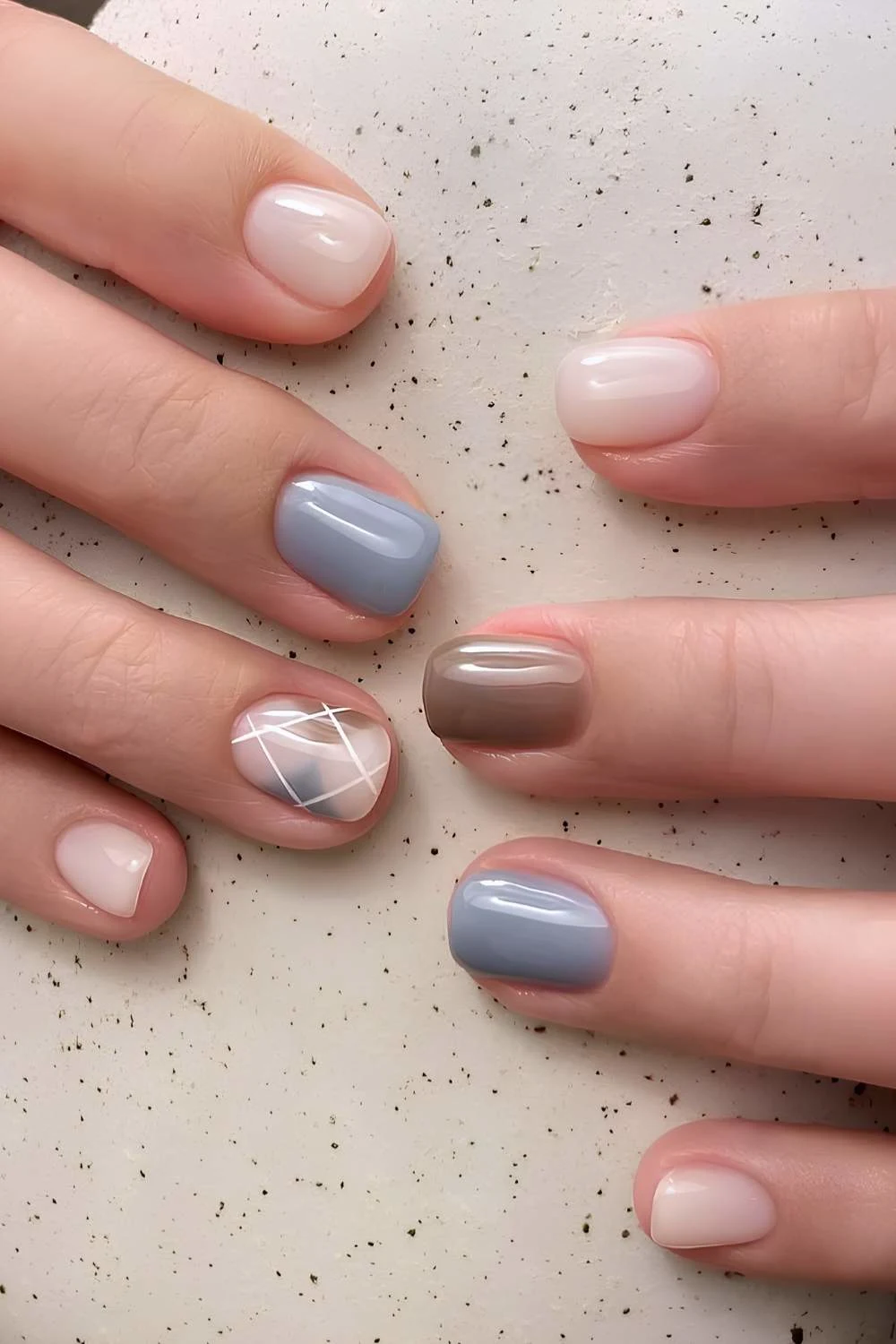 Blue and brown nails with argyle pattern art