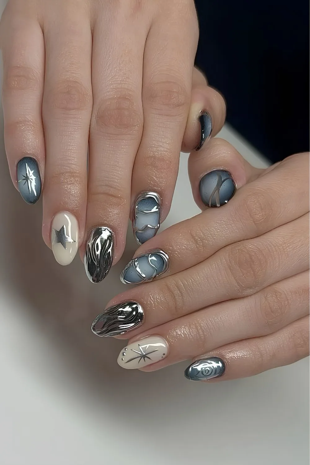 Blue and white nails with silver chrome accents