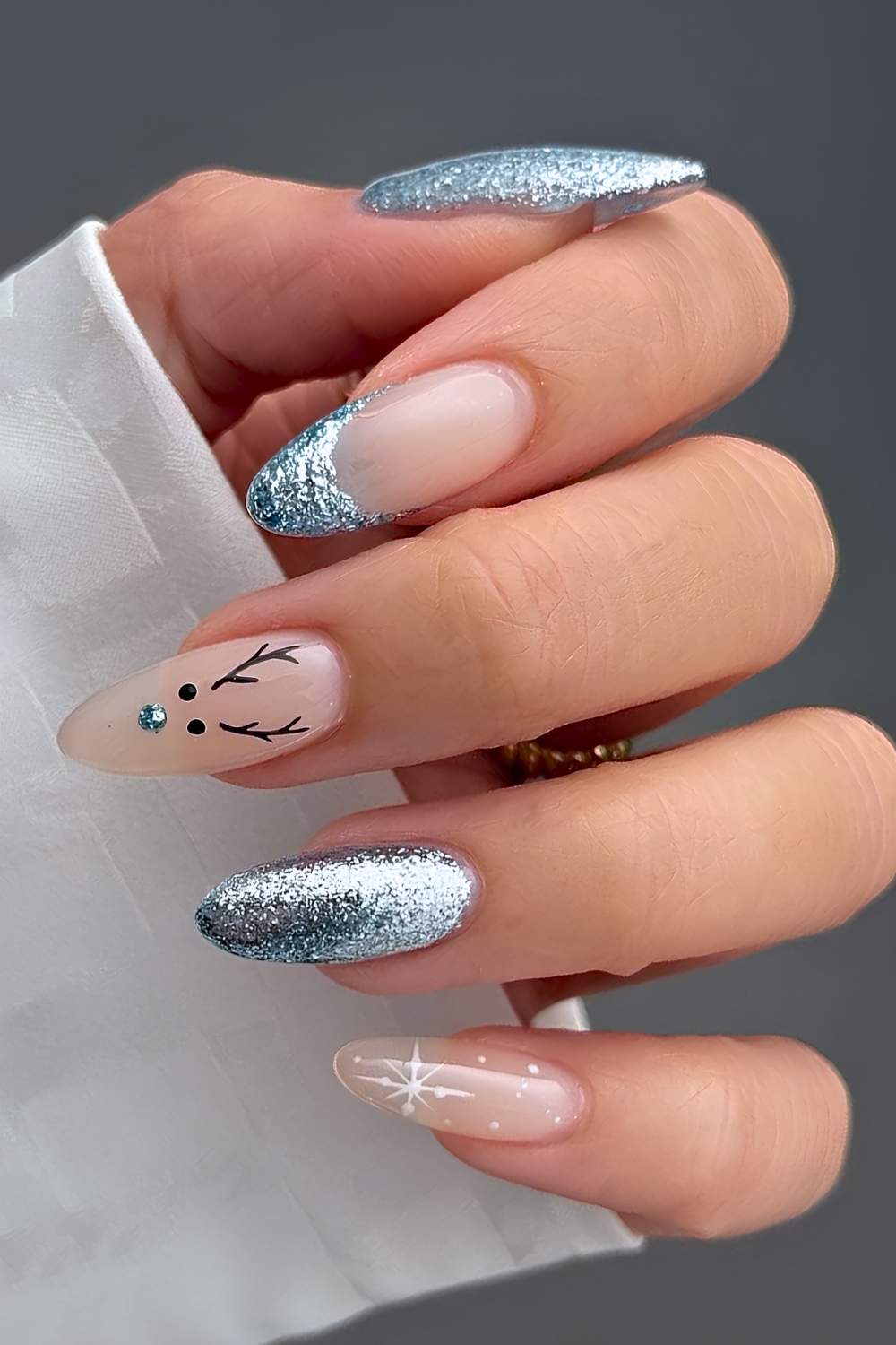Blue glitter nails with reindeer and snowflake art