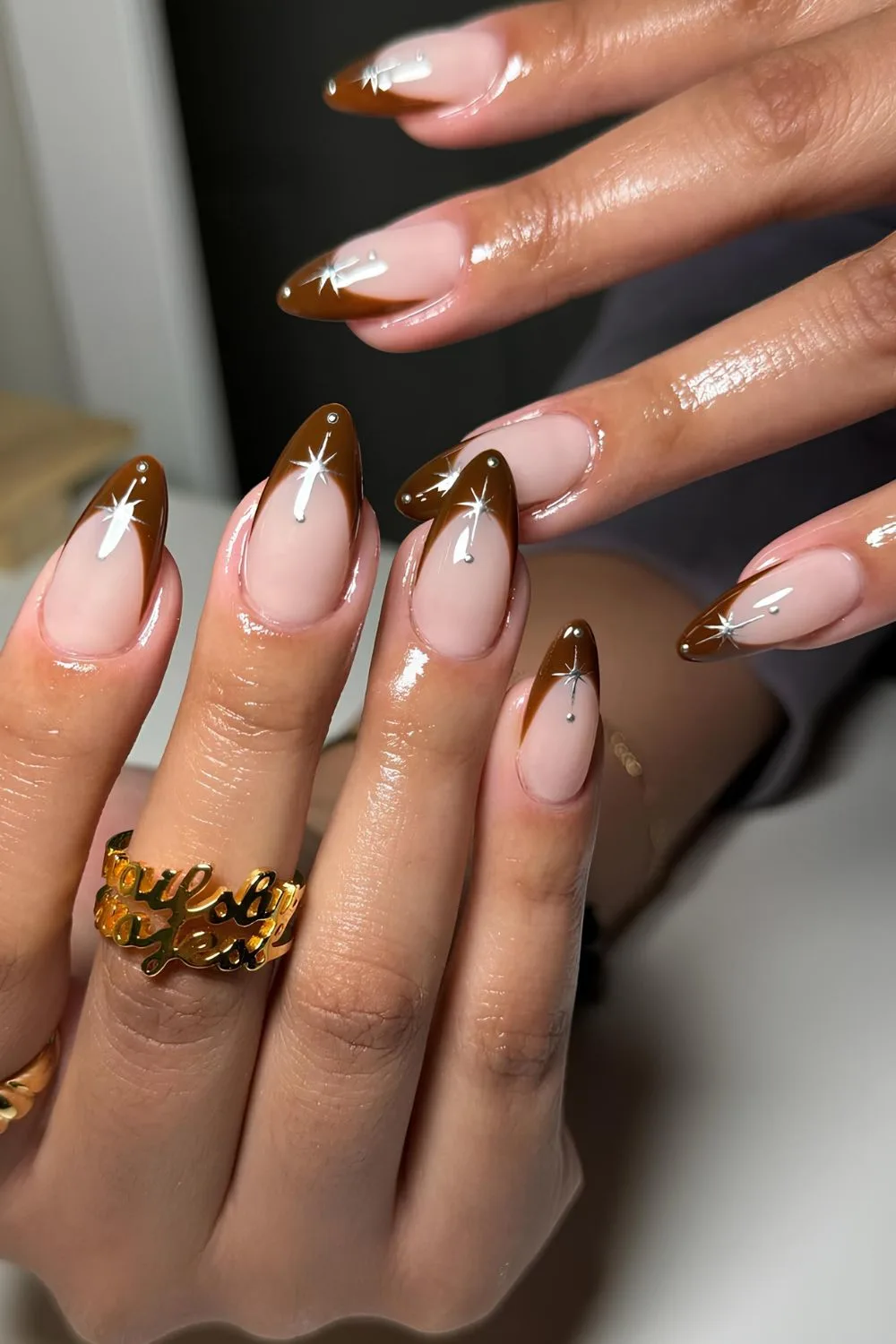 Brown French nails with celestial accents