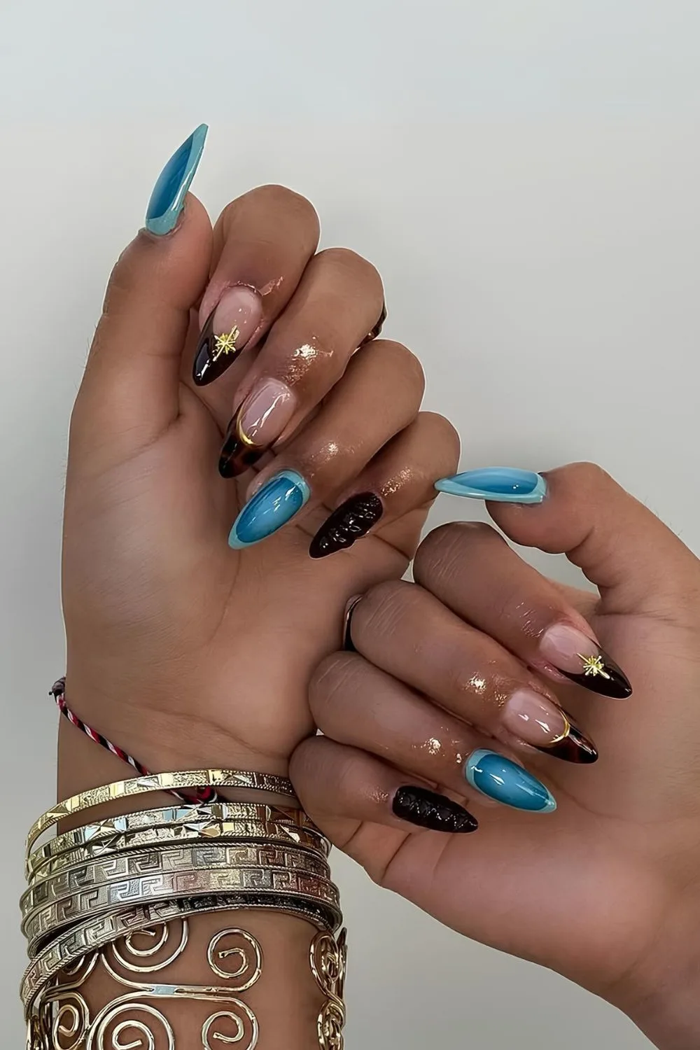 Brown and blue mix and match nails with gold accents