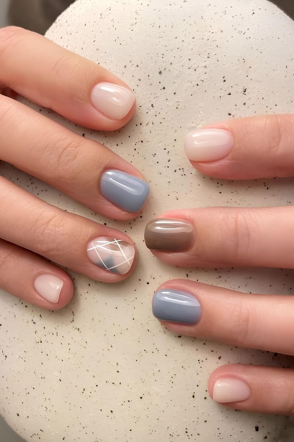 Brown and blue nails with argyle pattern accent