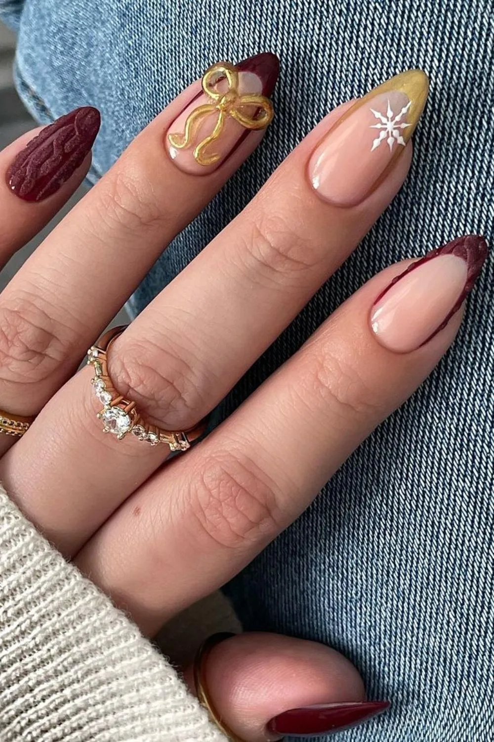 Burgubdy and gold French tip nails with 3D bow