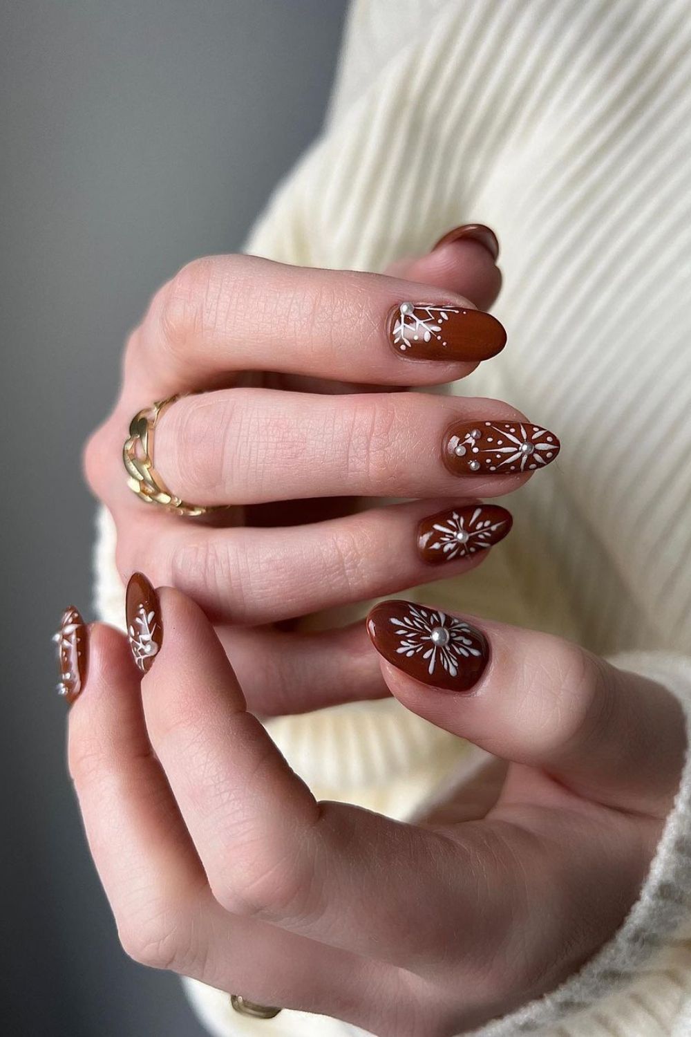 Brown nails with intrucate snowflake art