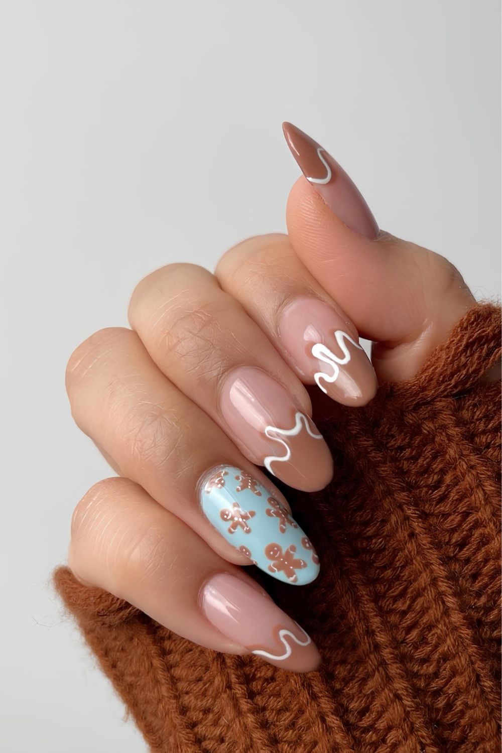 Brown swirly nails with blue and gingerbread accents