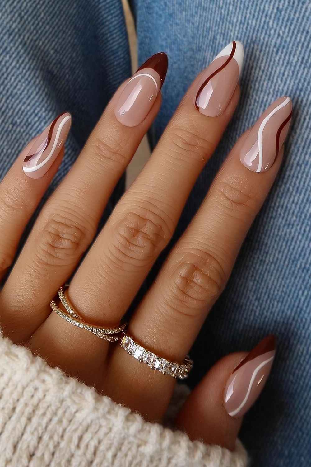 Burgundy and white French nails with swirls