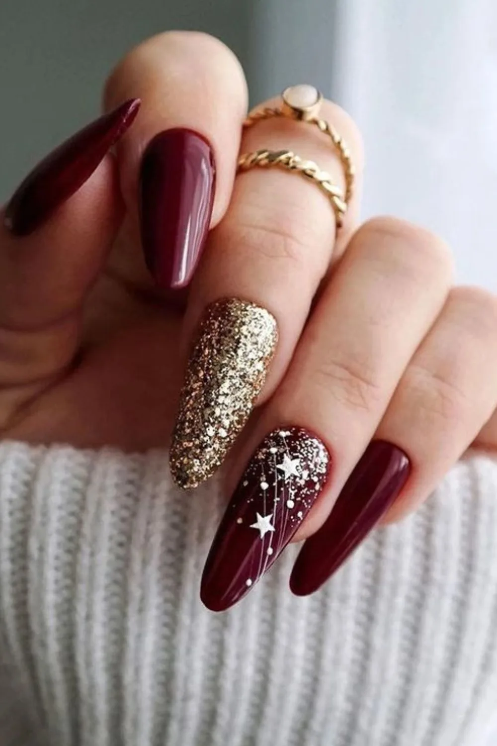 Burgundy nails with gold glitters and stars