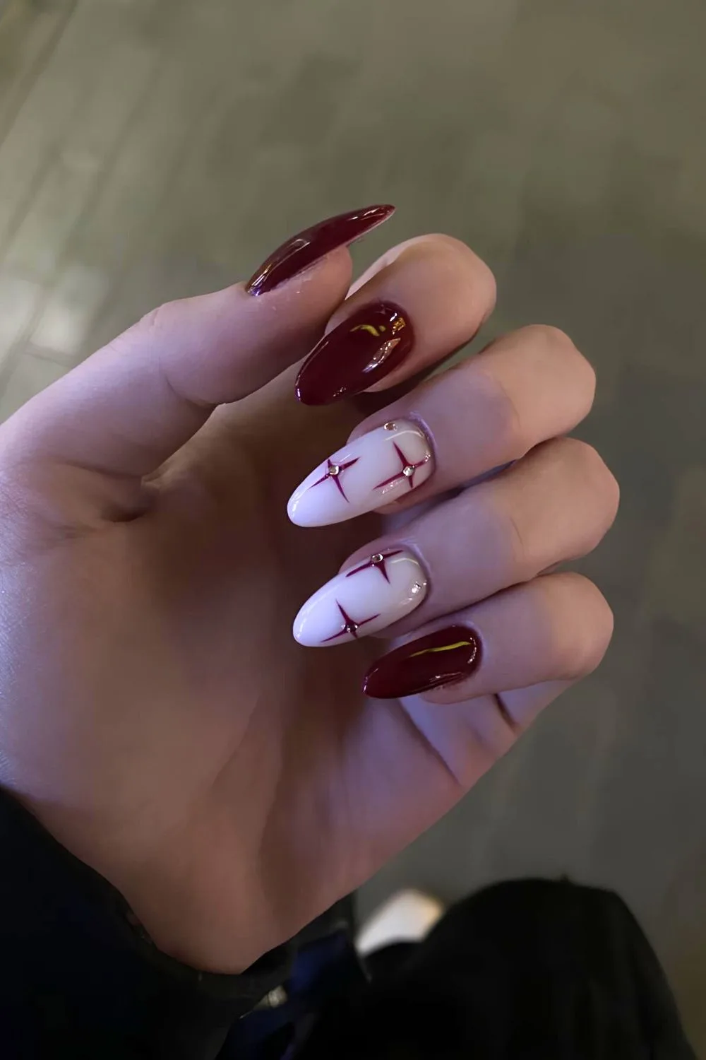 Cherry mocha and white nails with stars and rhinestones