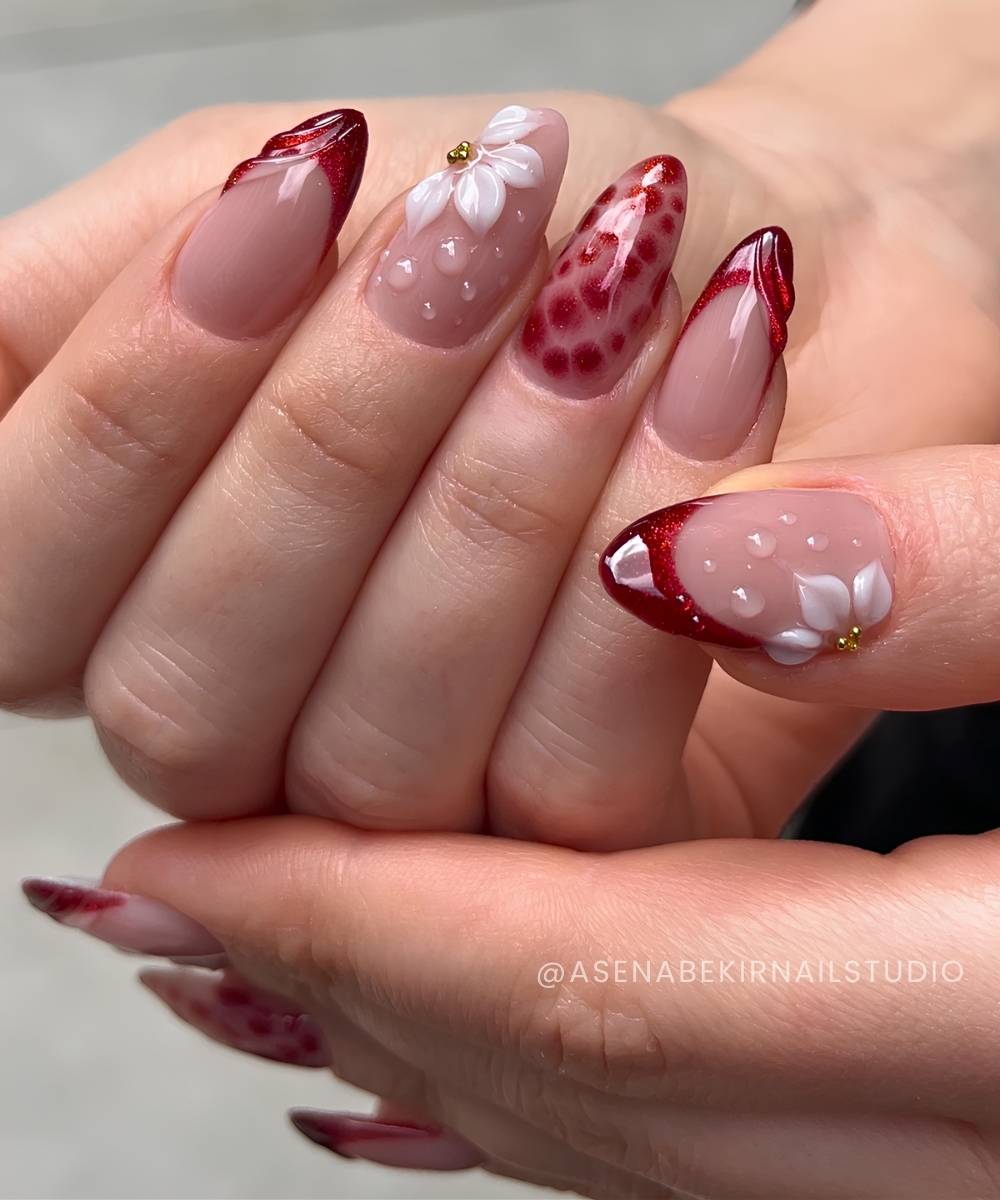 Cherry red French nails with textured swirls and flowers