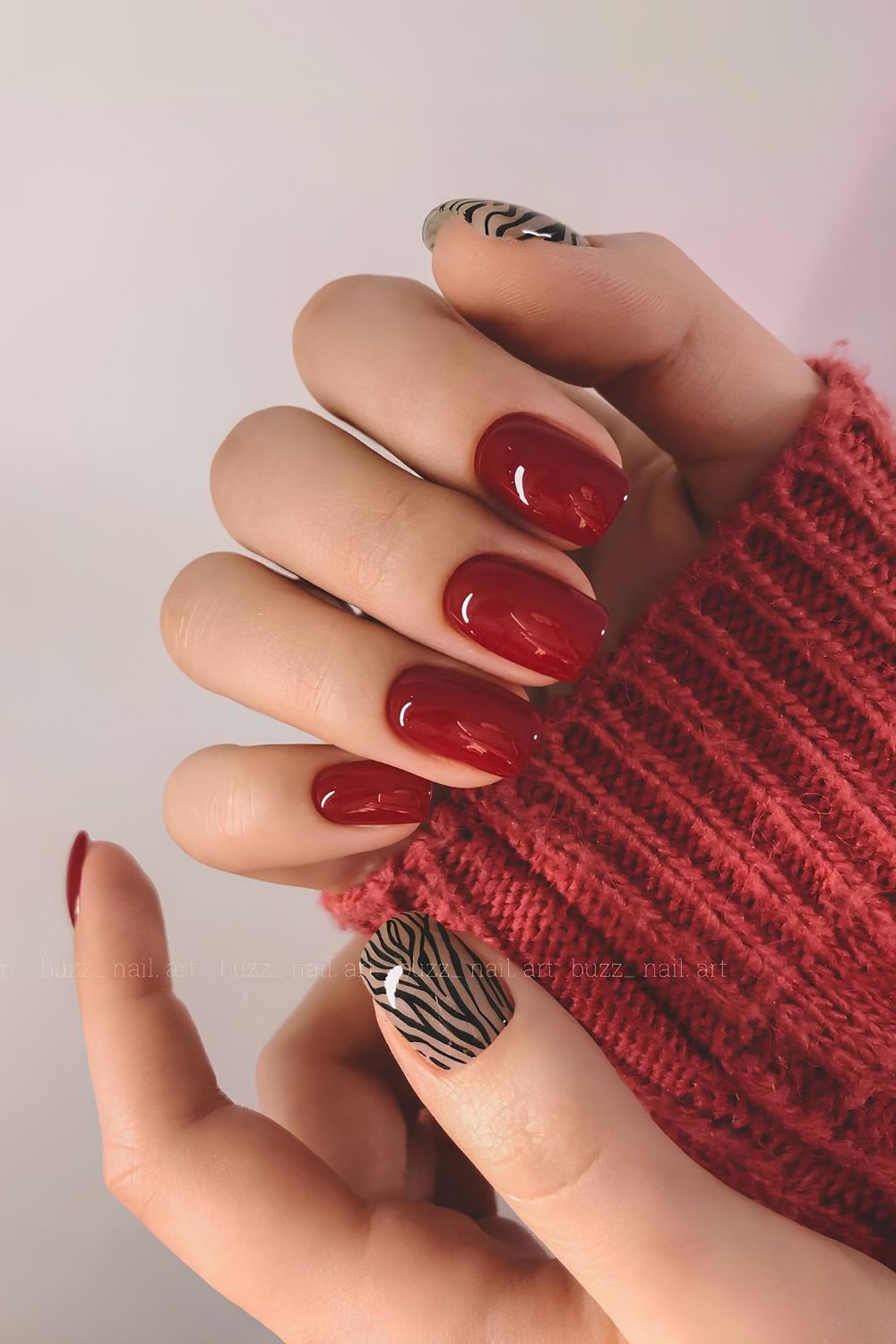 Cherry red nails with zebra print accent