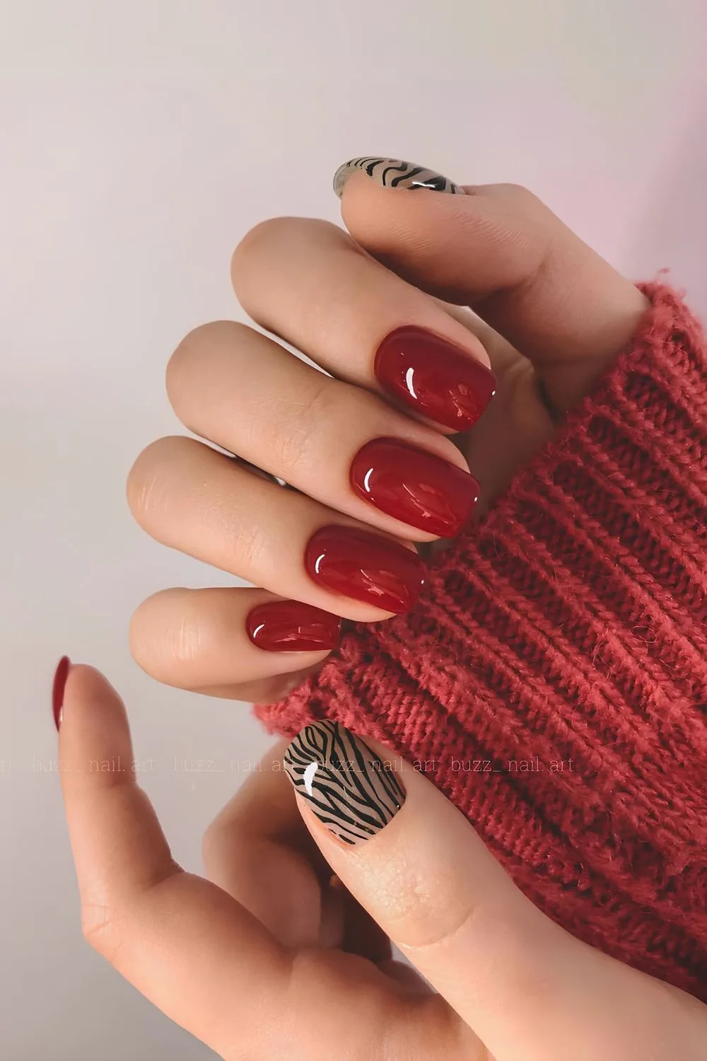 Cherry red nails with zebra print accent