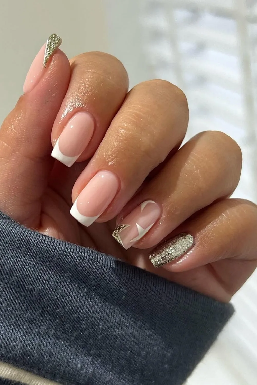 Classic French tip nails with glitter and stars