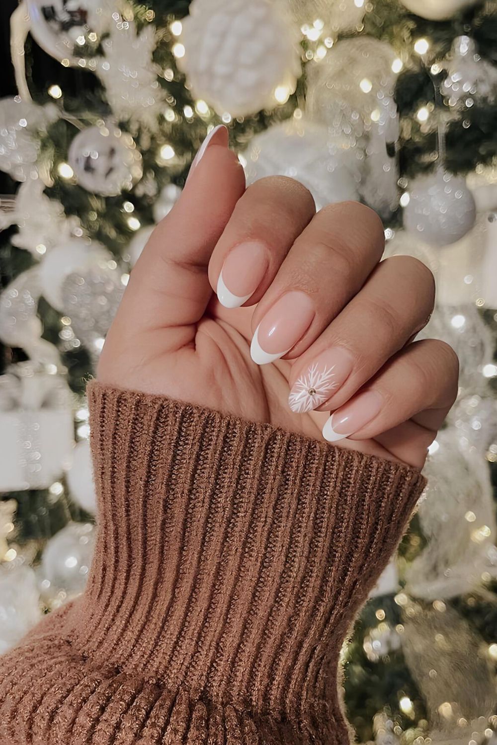 Classic white French mani with snowflake accent