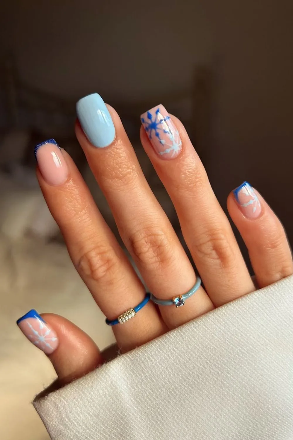 Dark and light blue nails with snowflakes