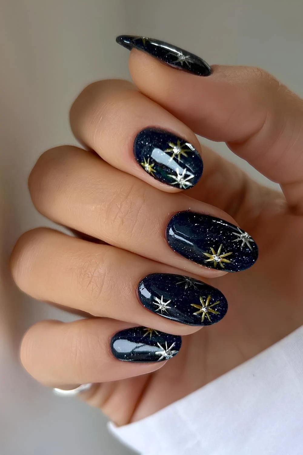 Dark blue winter nails with gold snowflakes