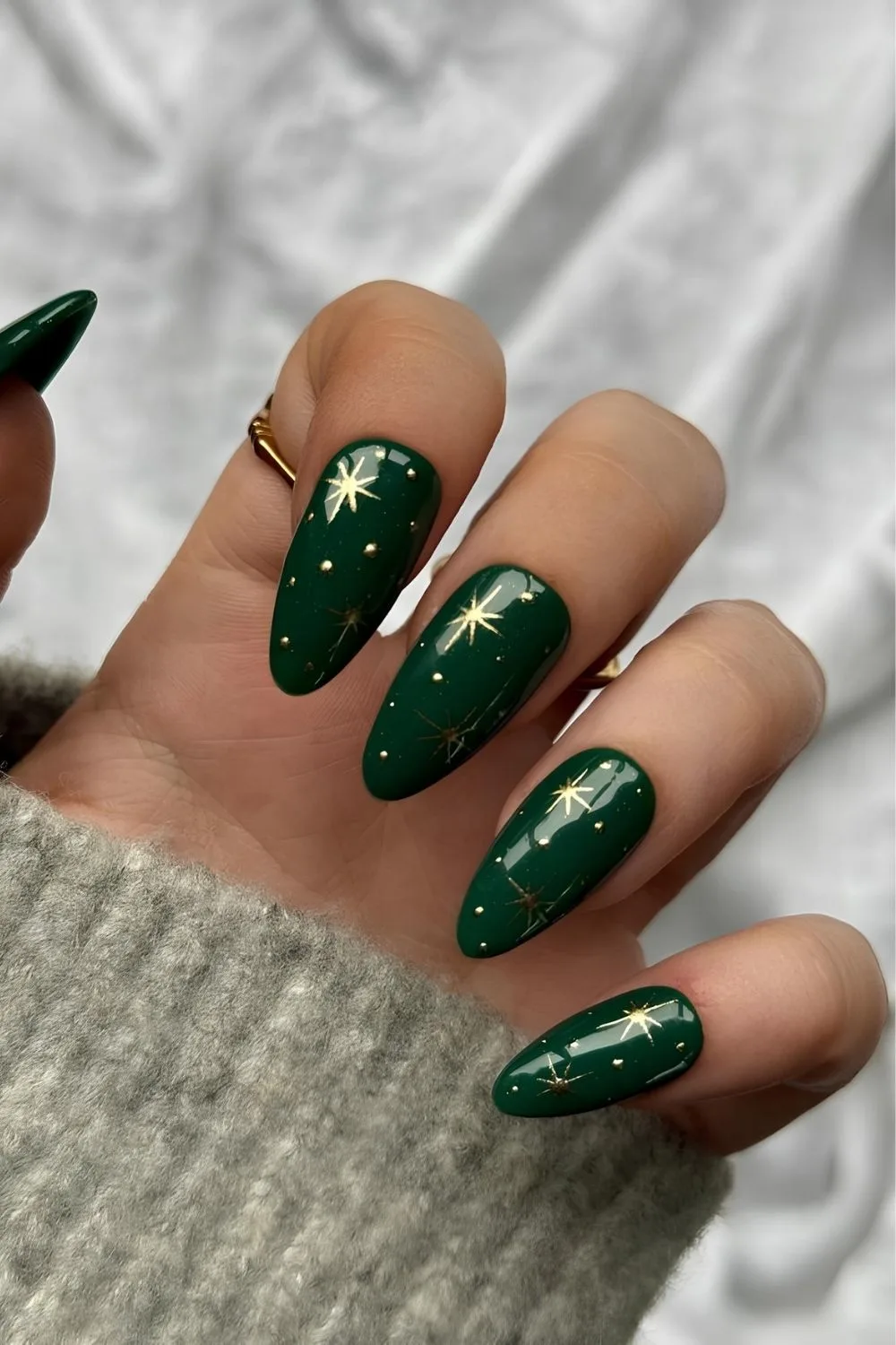 Dark green nails with gold stars