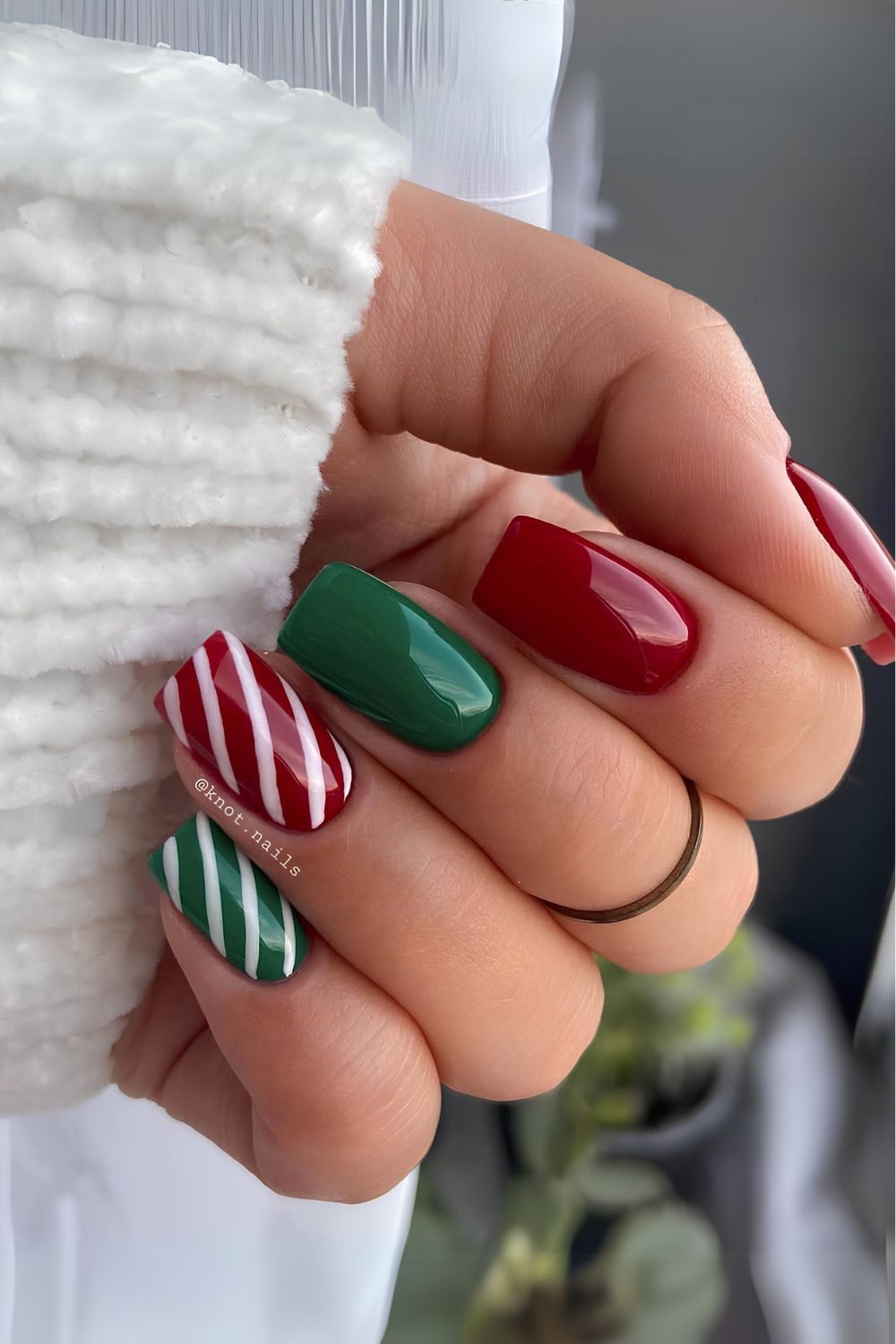 Dark red and green nails with candy cane stripes