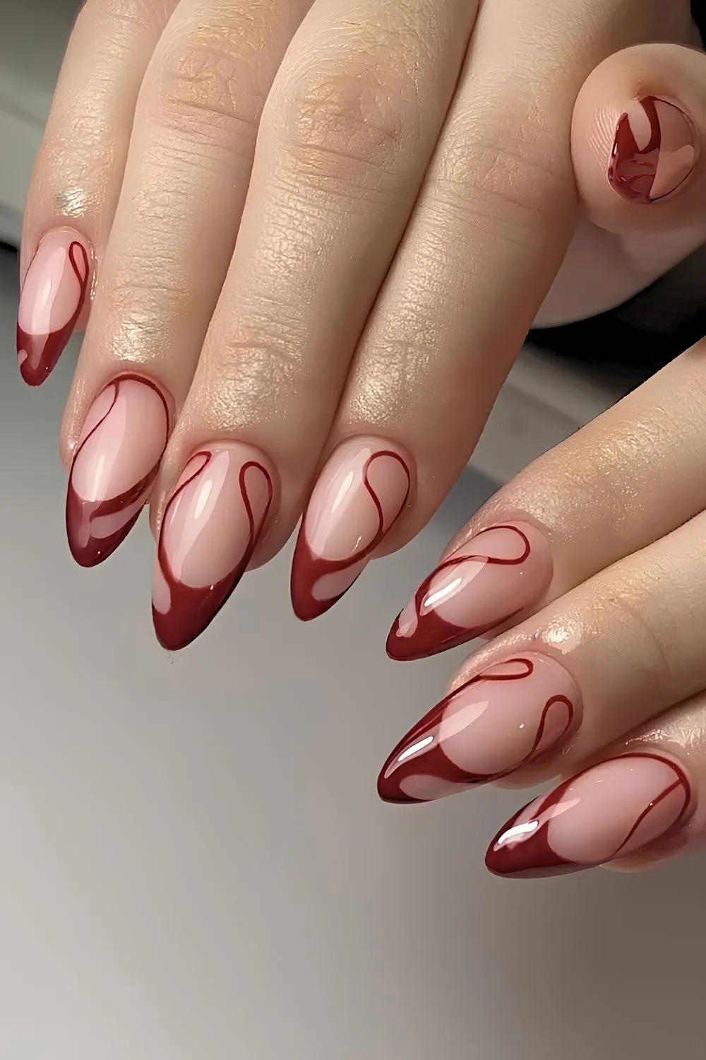 Dark red swirly French tip mani