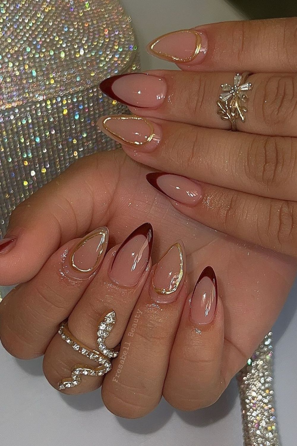 French tip nails with gold chrome accents